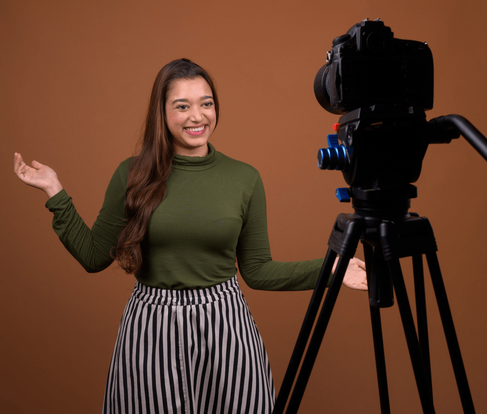 Woman in green jumper in front of camera